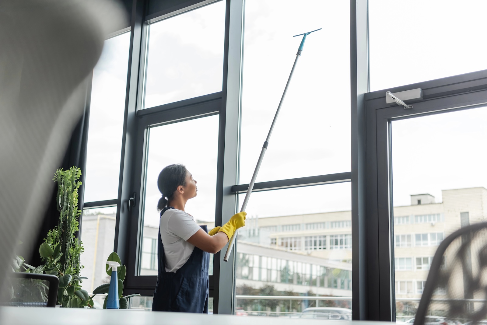 Commercial window cleaning professional cleaning the interior windows of an office space
