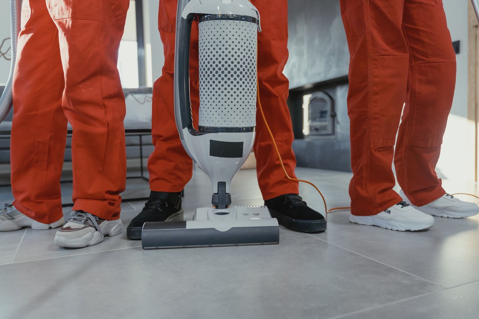 Commercial cleaner vacuuming carpet with professional equipment