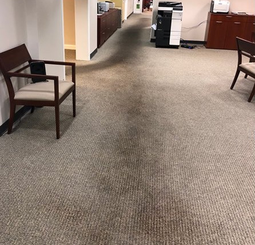 Office hallway carpet with visible soiling before cleaning